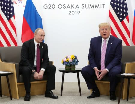 Russia's President Vladimir Putin and U.S. President Donald Trump attend a meeting on the sidelines of the G20 summit in Osaka