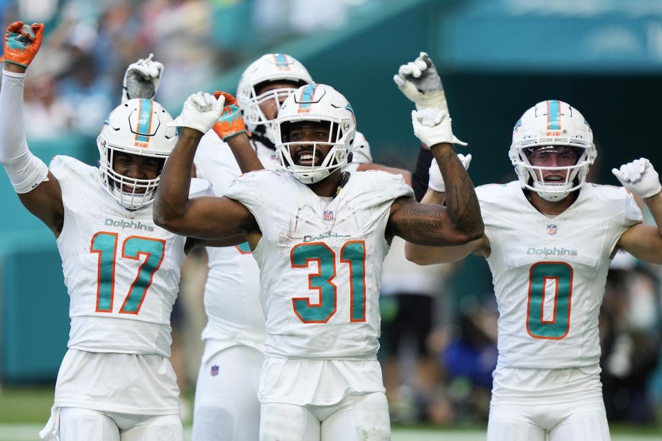 Miami Dolphins running back Raheem Mostert (31) celebrates with his teammates after scoring a touchdown during the second half of an NFL football game against the Carolina Panthers, Sunday, Oct. 15, 2023, in Miami Gardens, Fla. (AP Photo/Wilfredo Lee)