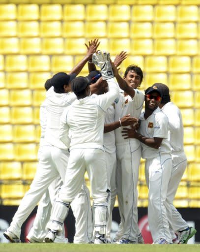 Sri Lankan bowler Suranga Lakmal (3rd left) celebrates with his teammates after he dismissed unseen Australian batsman Shane Watson during their second Test match at the Pallekele stadium in Pallekele. Shaun Marsh was 13 runs away from a century on his debut and Mike Hussey hit an unbeaten 76 as Australia piled on Sri Lanka's misery in the second Test in Pallekele