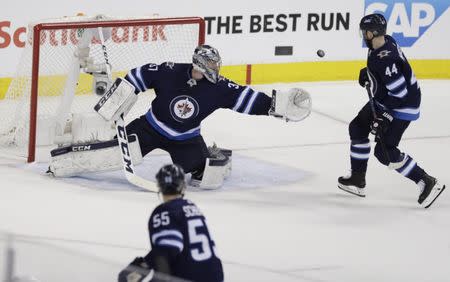 May 20, 2018; Winnipeg, Manitoba, CAN; Winnipeg Jets goaltender Connor Hellebuyck (37) catches the puck against the Vegas Golden Knights in the second period in game five of the Western Conference Final of the 2018 Stanley Cup Playoffs at Bell MTS Centre. Mandatory Credit: James Carey Lauder-USA TODAY Sports