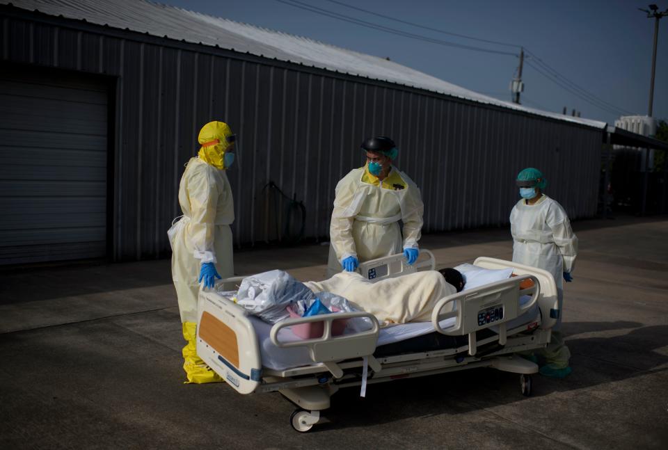 Healthcare workers push a patient into a less intensive unit from the COVID-19 Unit at United Memorial Medical Center in Houston, Texas on July 2, 2020. / Credit: MARK FELIX/AFP via Getty Images