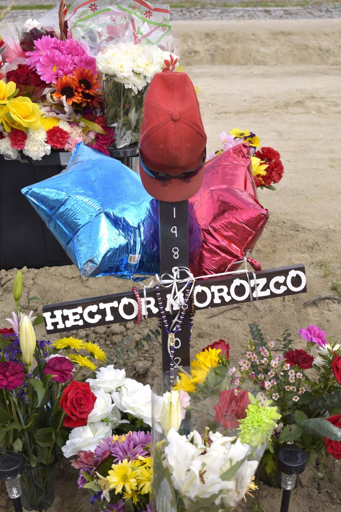 A cross in honor of Hector Manuel Orozco Ordoñez, 34, stands at the base of the memorial for farm workers in Madera. He was from the Mexican state of Jalisco.