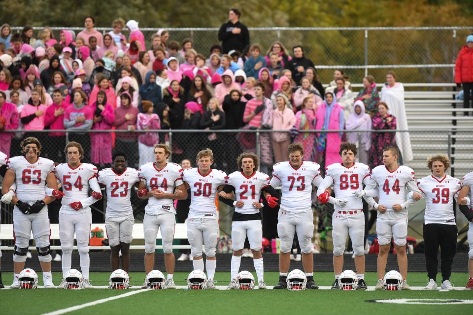 Lincoln football players stand for the pledge of allegiance at Brandon Valley High School on Friday, Oct. 6, 2023 at Brandon Valley High School in Brandon, South Dakota.