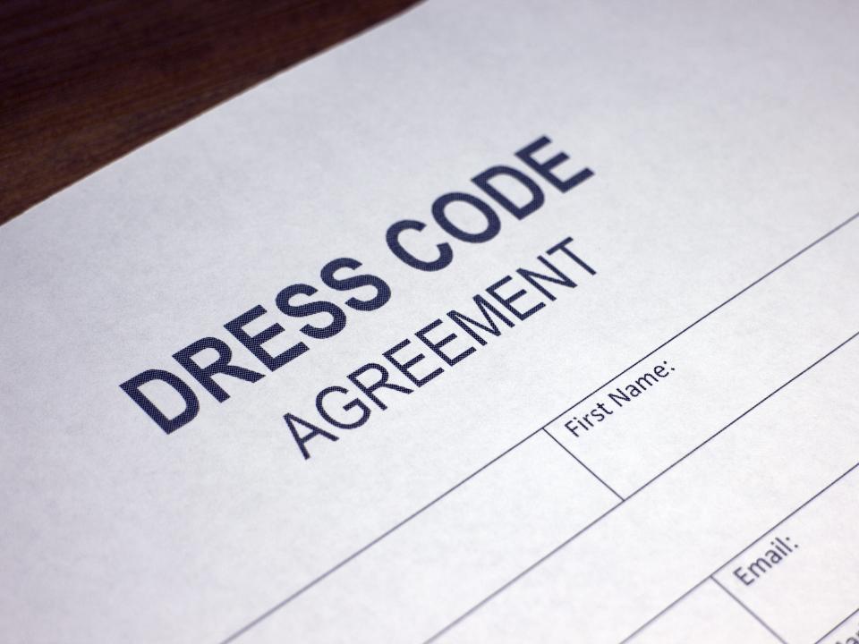 Someone filling out Dress Code Agreement.