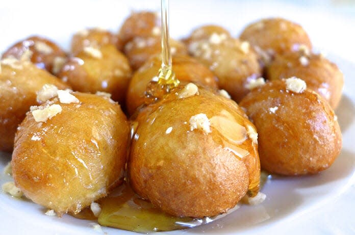 Loukoumádes is a popular street food served with a combination of honey, cinnamon and walnuts. It will be on the menu at the annual festival of the Greek Orthodox Church of the Annunciation on the parish grounds in Cranston.