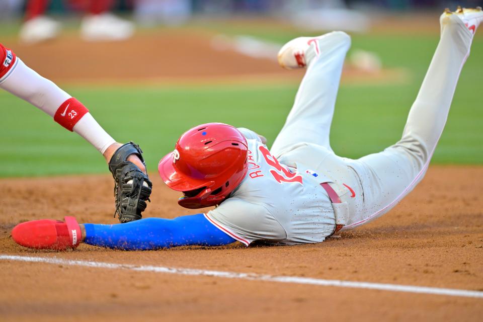 Philadelphia Phillies outfielder Johan Rojas (18) is picked off at first as he is tagged out by Los Angeles Angels first baseman Nolan Schanuel (18) in the second inning Monday at Angel Stadium in Anaheim, California.