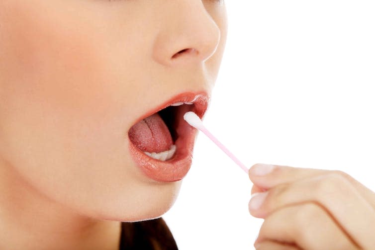 <span class="caption">Oral swaps and saliva samples are used by Direct To Consumer commercial genetic tests.</span> <span class="attribution"><a class="link " href="https://www.shutterstock.com/image-photo/young-woman-putting-ear-stick-into-446399410?src=9EmiICl3YxqNCikbeGBPhg-1-7" rel="nofollow noopener" target="_blank" data-ylk="slk:B-DSPiotrMarcinsk/Shutterstock;elm:context_link;itc:0;sec:content-canvas">B-DSPiotrMarcinsk/Shutterstock</a></span>