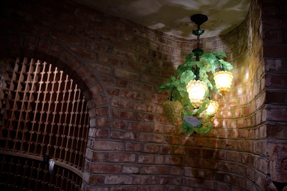 This unique chandelier is defined by its glass leaves and golden grapes, which hide the bulbs. An online auction of items from Villa Collina will take place Dec. 4 before Knoxville's largest home is eventually demolished and replaced with three smaller homes.