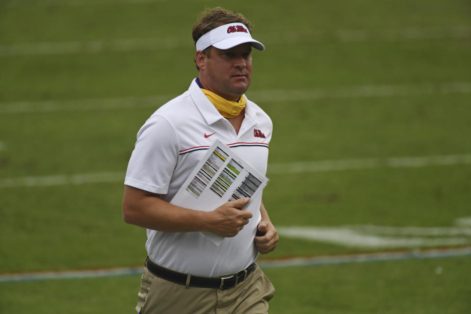 Mississippi head coach Lane Kiffin runs off the field after the first half of an NCAA college football game between Mississippi and Florida in Oxford, Miss., Saturday, Sept. 26, 2020. (AP Photo/Thomas Graning)