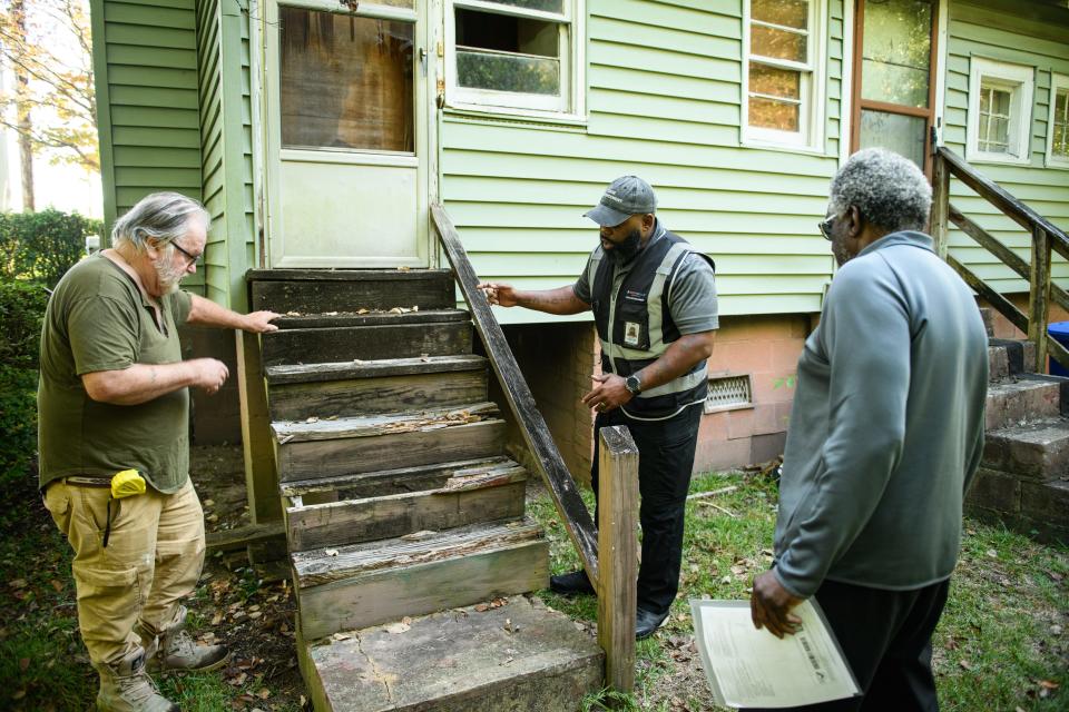 Code enforcement officer Dereke Planter Jr., center, goes over a home on Murchison Road with contractor Bob Rogers, left, to point out anything that needs to be done to the home to bring it up to code, Wednesday, Oct. 4, 2023.