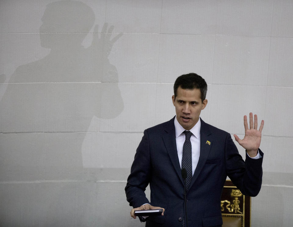 FILE - In this Jan. 5, 2019, file photo, Venezuelan lawmaker Juan Guaido takes the oath of office as president of the National Assembly in Caracas, Venezuela. A coalition of Latin American governments that joined the U.S. in quickly recognizing Guaido as Venezuela’s interim president, and not Nicolas Maduro, came together during weeks of secret diplomacy. (AP Photo/Fernando Llano, File)