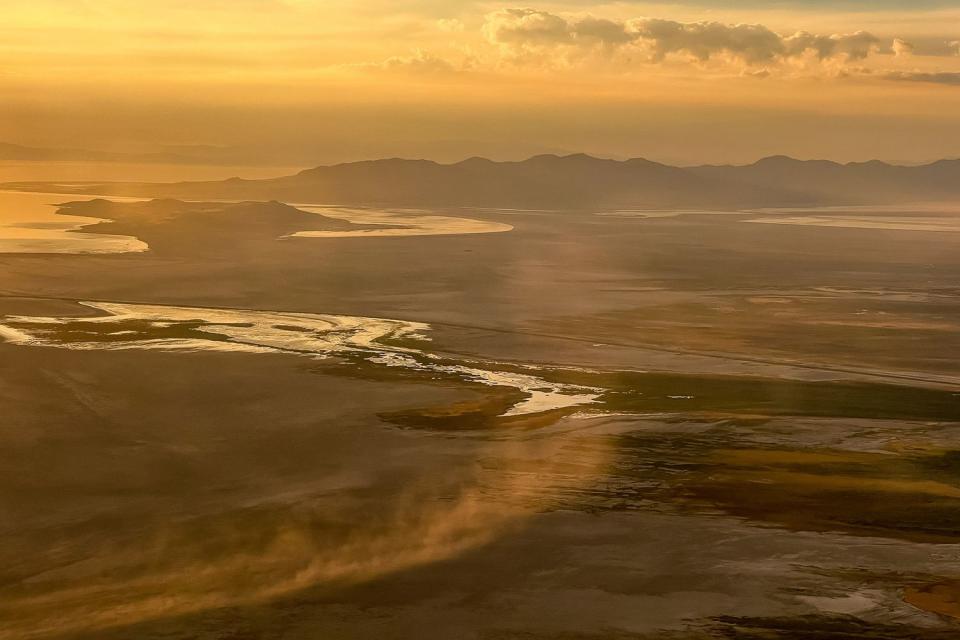 Dust blows across the dry lakebed of the Great Salt Lake near Salt Lake City on Aug. 12, 2022.