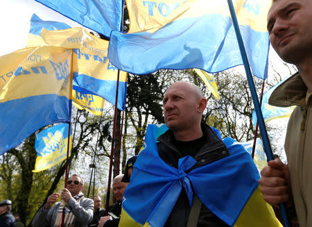 People attend a rally in support of Ukrainian President Petro Poroshenko's appeal to Ecumenical Patriarch Bartholomew to create a unified Ukrainian Orthodox church free from the influence of Russia, in front of the parliament in Kiev, Ukraine April 19, 2018. REUTERS/Valentyn Ogirenko