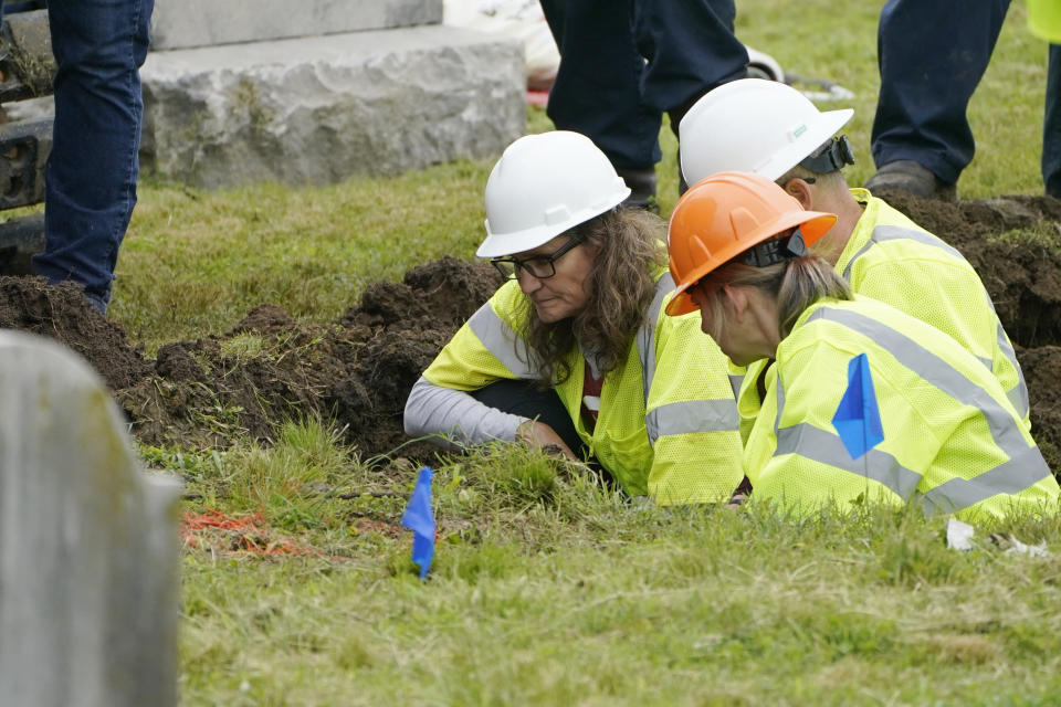 Oklahoma state archaeologist Kary Stackelbeck, left, examines the digging site as excavation begins at Oaklawn Cemetery in a search for victims of the Tulsa Race Massacre believed to be buried in a mass grave, Tuesday, June 1, 2021, in Tulsa, Okla. (AP Photo/Sue Ogrocki)