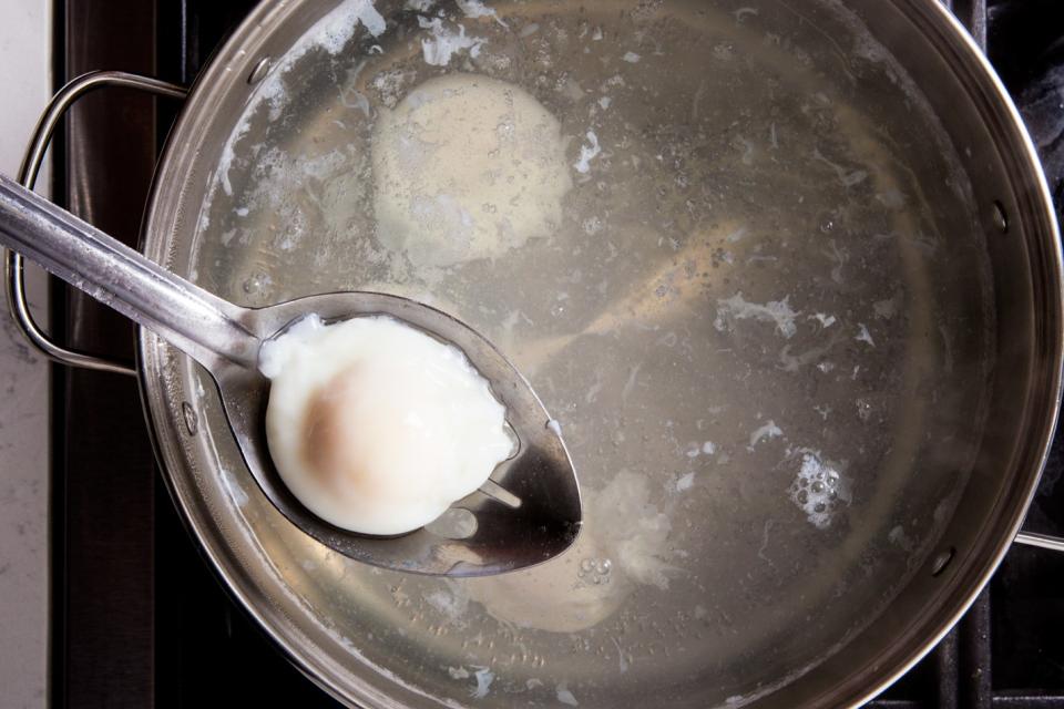 When the egg is done, use the slotted spoon to carefully remove it from the hot water. To serve immediately, place a paper towel under the spoon and shake gently to remove some of the excess water. Reserve on an oiled plate until remaining eggs are finished. Or...