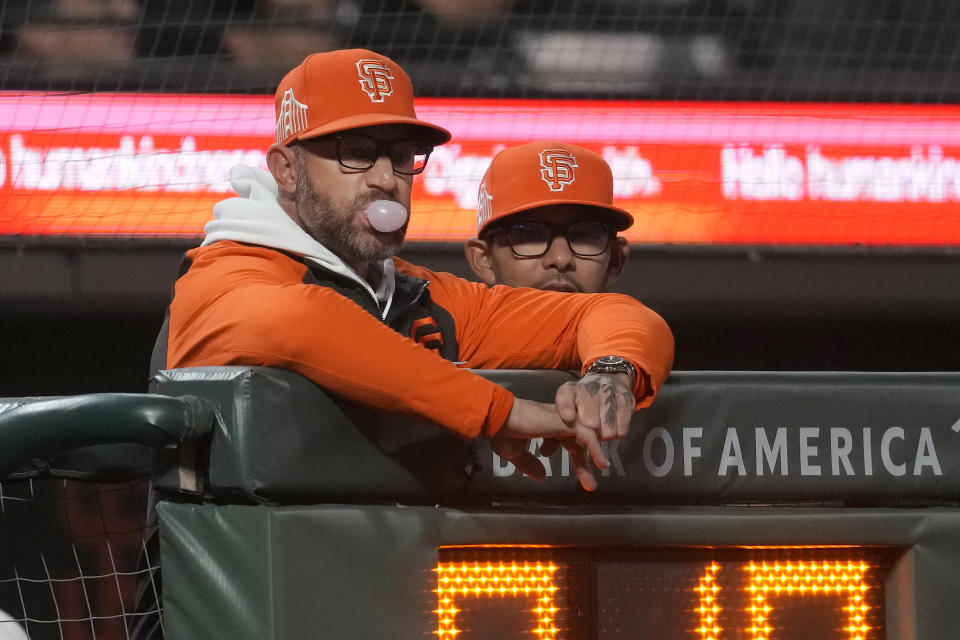 San Francisco Giants manager Gabe Kapler, left, watches from the dugout during the ninth inning of the team's baseball game against the San Diego Padres in San Francisco, Tuesday, Sept. 26, 2023. (AP Photo/Jeff Chiu)