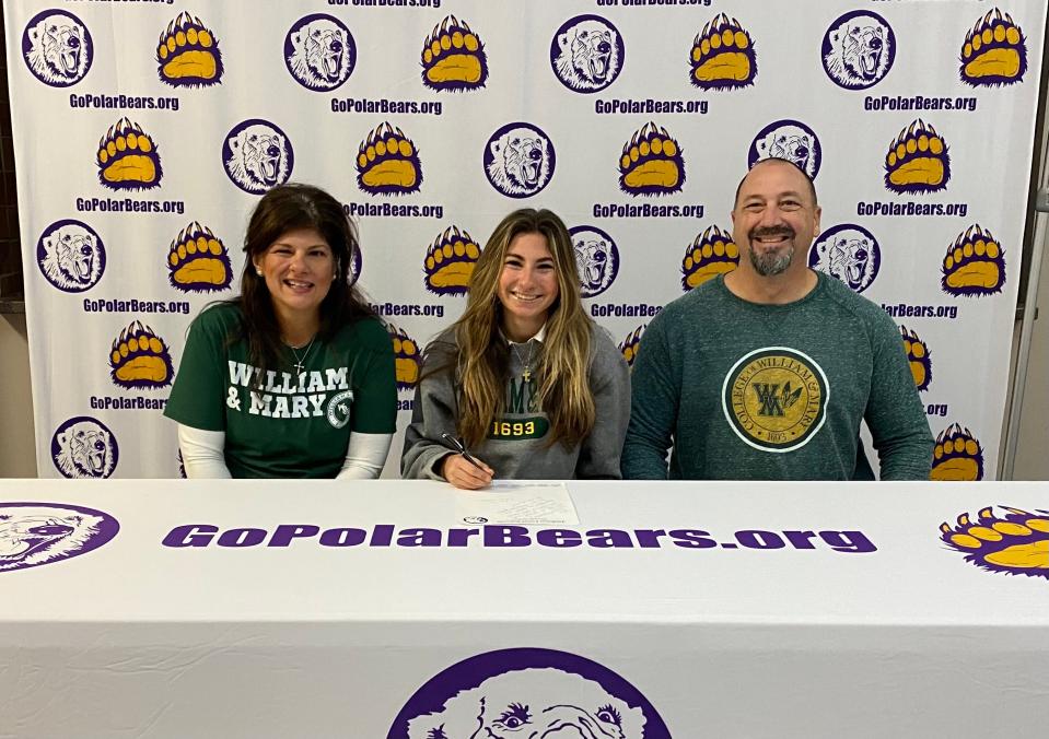 Jackson High School's Sofia Istnick is joined by her parents Anna and Rick as she signs her national letter of intent to run cross country and track at William & Mary.