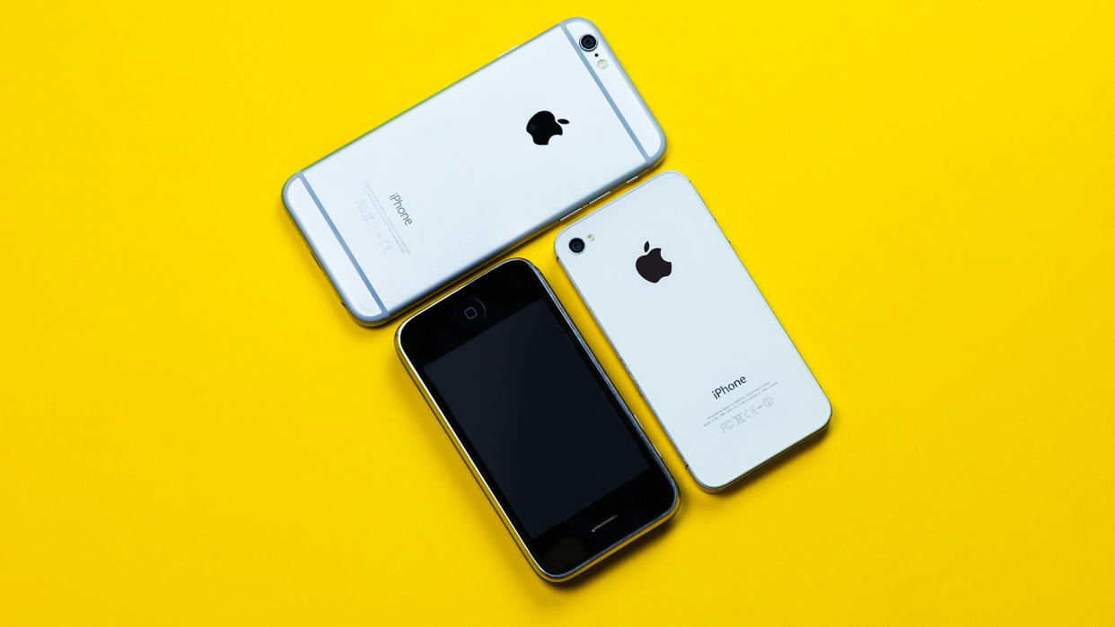  Old iPhones on yellow background. 