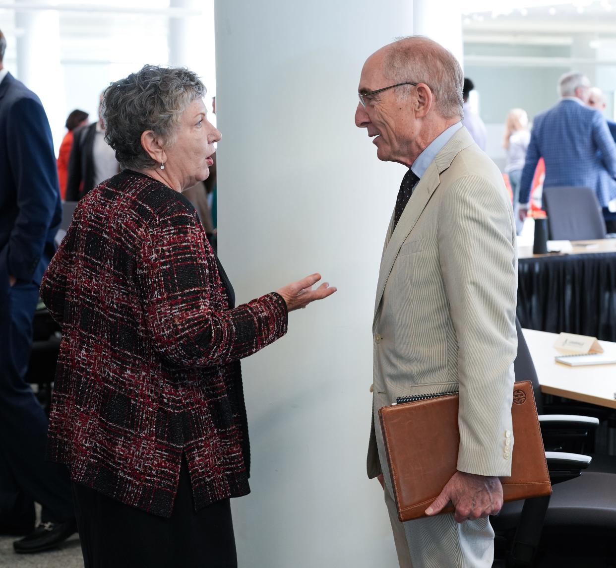 University of Louisville President Kim Schatzel, left, chatted with University of Kentucky President Eli Capilouto following the inaugural meeting of the Louisville Economic Development Alliance at the Humana Waterside building in Louisville, Ky. on July 17, 2024.