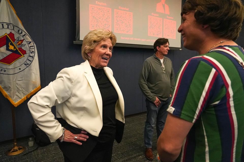 Sara Hensley, candidate for Austin City Manager and City Manager of Denton, Texas, speaks to Austin resident Skyler Korgel after an open town hall at the Permitting and Development Center on Monday.