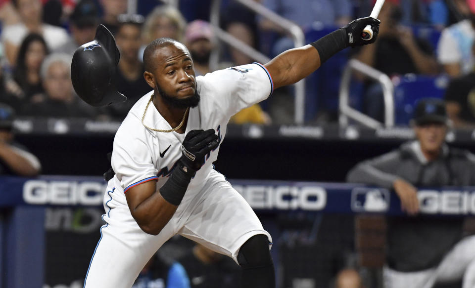 Miami Marlins' Bryan De La Cruz (14) strikes out swinging during the eighth inning of the team's baseball game against the St. Louis Cardinals, Tuesday, April 19, 2022, in Miami. (AP Photo/Jim Rassol)