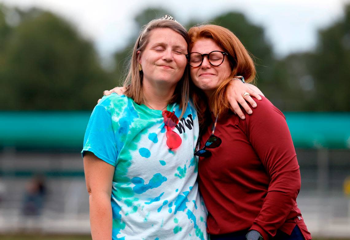 Whitford Wooten, left, hugs her sister Carrington Burton, as Wooten is honored before Ravenscroft High School’s field hockey game against St. Mary’s School Tuesday, Oct. 10, 2023. Wooten, an assistant coach on the team, has ALS (amyotrophic lateral sclerosis or Lou Gehrig’s disease), a progressive neurodegenerative disease.