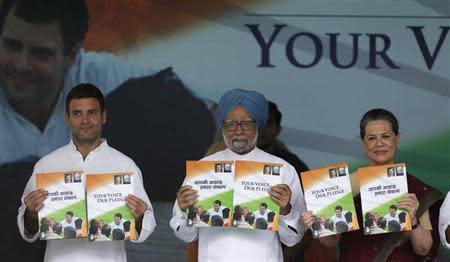 Prime Minister Manmohan Singh (C), Chief of India's ruling Congress party Sonia Gandhi (R) and her son Rahul Gandhi, vice president of the party, hold copies of their party's election manifesto for the April/May general election in New Delhi March 26, 2014. REUTERS/Adnan Abidi