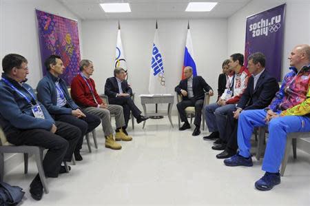 Russia's President Vladimir Putin (5th R), nternational Olympic Committee (IOC) President Thomas Bach (4th L) and other officials attend a meeting during the Sochi 2014 Winter Olympic Games February 15, 2014. REUTERS/Mikhail Klimentyev/RIA Novosti/Kremlin