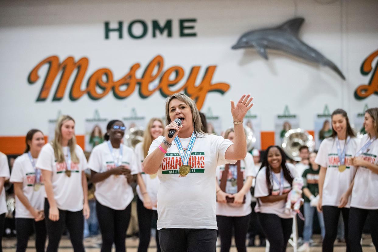 Mosley coach Michelle Mask salutes the fans. Teachers, students and fans celebrated Mosley's volleyball state title with a homecoming pep rally at the school Thursday, November 18, 2021.