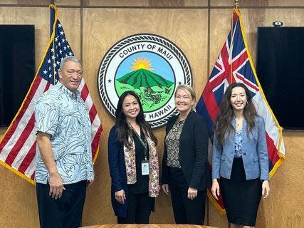 Lisa Paulson poses for a photo with Maui Mayor Richard Bissen and Maui County officials.