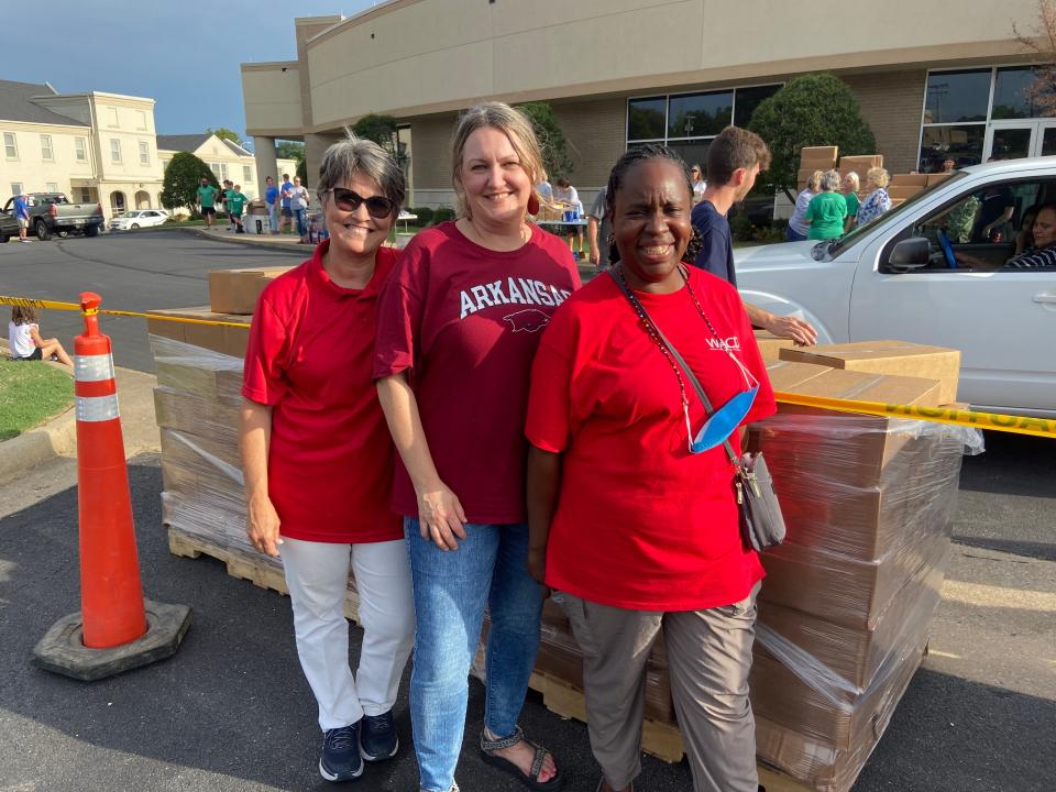 Malinda McSpadden, CEO of Western Arkansas Child Development, LaToya Shepherd a volunteer and Kara Burns, WACD Board President stand with their boxes of food donations at the Back to School Bash.