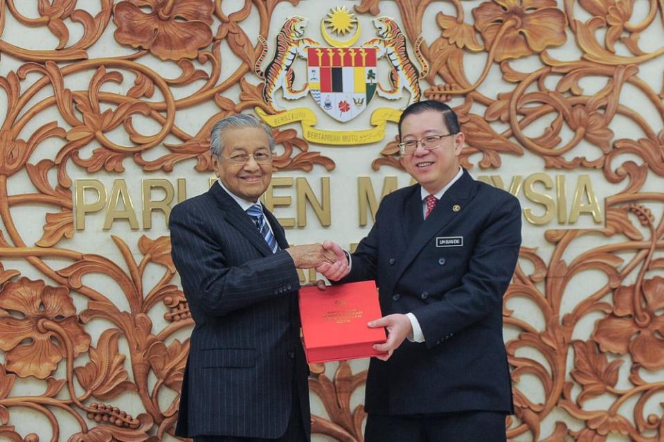 Finance Minister Lim Guan Eng and Prime Minister Tun Dr Mahathir Mohamad pose with a copy of the Budget 2019 report in Parliament November 2, 2018. — Picture by Shafwan Zaidon