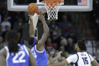 Kentucky forward Oscar Tshiebwe (34) grabs a rebound next to Gonzaga center Efton Reid III (15) during the first half of an NCAA college basketball game, Sunday, Nov. 20, 2022, in Spokane, Wash. (AP Photo/Young Kwak)