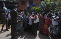 Family members of inmates gather demanding to know the condition of their relatives outside the Mahara prison complex following an overnight unrest in Mahara, outskirts of Colombo, Sri Lanka, Monday, Nov. 30, 2020. Sri Lankan officials say six inmates were killed and 35 others were injured when guards opened fire to control a riot at a prison on the outskirts of the capital. Two guards were critically injured. Pandemic-related unrest has been growing in Sri Lanka's overcrowded prisons. (AP Photo/Eranga Jayawardena)