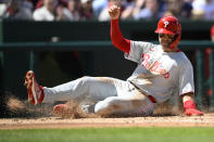Philadelphia Phillies' Whit Merrifield slides home to score on a single by Edmundo Sosa during the second inning of a baseball game, Sunday, April 7, 2024, in Washington. (AP Photo/Nick Wass)