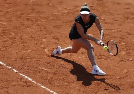 Simona Halep of Romania plays a shot to Evgeniya Rodina of Russia during their women's singles match at the French Open tennis tournament at the Roland Garros stadium in Paris, France, May 24, 2015. REUTERS/Vincent Kessler