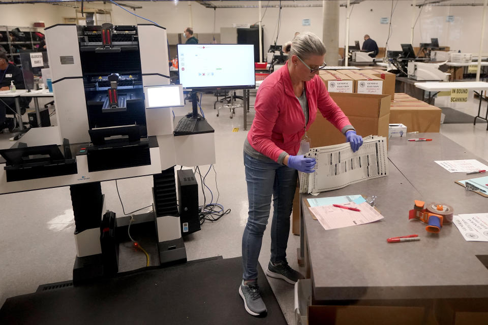 An election worker boxes tabulated ballots inside the Maricopa County Recorders Office, Wednesday, Nov. 9, 2022, in Phoenix. (AP Photo/Matt York)