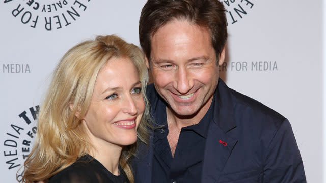 Just when we thought we couldn't be any more excited about Fox's upcoming <em>X-Files</em> revival, something comes along that fills us with even more anticipation! On Tuesday, series stars David Duchovny and Gillian Anderson reunited on set where the co-stars made the hearts of all <em>X-Files</em> fans beat faster when they shared a sweet kiss. Splash News <strong>WATCH: 'X-Files' Stars David Duchovny and Gillian Anderson Share a Kiss on Stage! </strong> It's unclear if the kiss was a friendly hello, or part of a scene. To be fair, it's never been that hard for Duchovny and Anderson to make <em>X-Files</em> fans swoon. Like when they kissed on stage last month at a live performance of Duchovny's debut album. That caused quite the stir among fans. <strong>NEWS: David Duchovny Clears Up Gillian Anderson Dating Rumors: 'It's Not Going to Happen' </strong> On Monday, Anderson really stoked the fandom flames when she tweeted a picture of two set chairs with "Mulder" and "Scully" embroidered on the backrests, as well as the message, "And so it begins..." And so it begins... pic.twitter.com/FSDI7W0bMK— Gillian Anderson (@GillianA) June 9, 2015 Adding to that excitement, Duchovny tweeted another picture of his chair, this time with a script sitting on it. Look closely even in the dark you see pic.twitter.com/Q1FUlxIH8h— David Duchovny (@davidduchovny) June 9, 2015 <strong>NEWS: Dana Scully Is Back! Gillian Anderson Dyes Hair Red for 'The X-Files' Reboot </strong> <em>X-Files</em> creator Chris Carter, who is also helming the revival, joined Instagram to celebrate and document the production. He commemorated the start of principal photography with his very first post, sharing a pic of a slate. Premiering in 1993, <em>X-Files</em> came to an end in 2002 after nine seasons and two feature films in 1998 and 2008. The popular series earned 16 Emmys, five Golden Globes and a Peabody Award. <strong>PHOTOS: The '90s Are Back! Retro Reboots Coming to Your TV </strong> The six-part limited series revival returns to Fox on Jan. 24, 2016. Last week, Anderson made headlines when she wore a sheer, nude-colored gown to the Glamour UK Women of the Year Awards, and ended up showing a little more than she bargained for. Check out the video below to see how she managed to stay classy, even during a slight wardrobe malfunction.