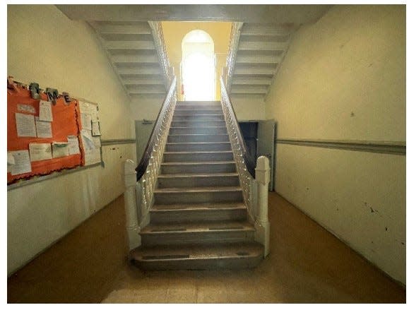 The stairwell in the old Princess Street School, later the Princess Street Center. The building is now closed after sustaining water damage.