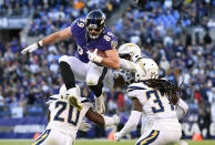 <p>Baltimore Ravens tight end Mark Andrews (89) leaps over Los Angeles Chargers defenders as he rushes the ball in the second half of an NFL wild card playoff football game, Sunday, Jan. 6, 2019, in Baltimore. (AP Photo/Nick Wass) </p>