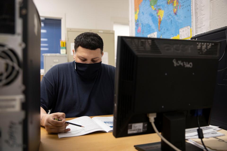 Cody Madrid, a prisoner at Snake River Correctional Institution in Ontario, Ore., studies in class on Thursday, May 12, 2022. Madrid earned a high school diploma but is still working on his reading skills so he can test at the eighth-grade level.