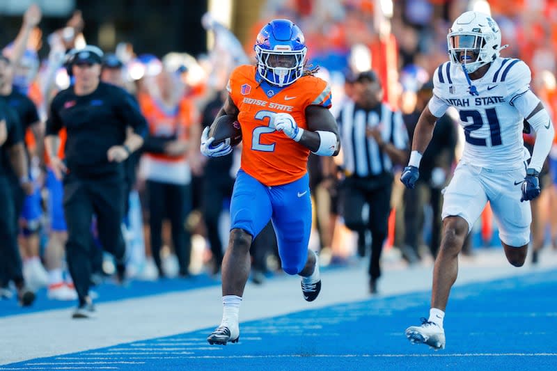 Boise State running back Ashton Jeanty (2) runs away from Utah State safety Malik McConico (21) on a 75-yard touchdown run in the first half of an NCAA college football game, Saturday, Oct. 5, 2024, in Boise, Idaho. . (AP Photo/Steve Conner) | Steve Conner