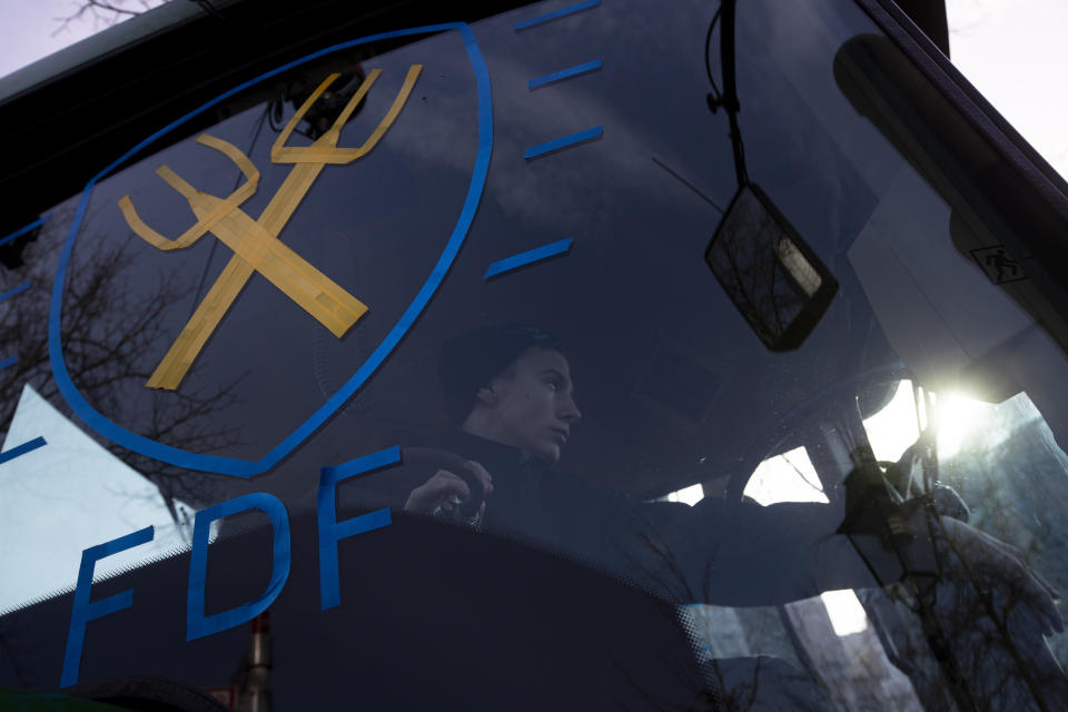 The logo of the Farmers Defense Force is taped onto the window of a tractor as some thousand of farmers converged on The Hague, Netherlands, Wednesday, Feb. 19, 2020, in the latest protest against the government's plans to rein in emissions of nitrogen oxide. (AP Photo/Peter Dejong)