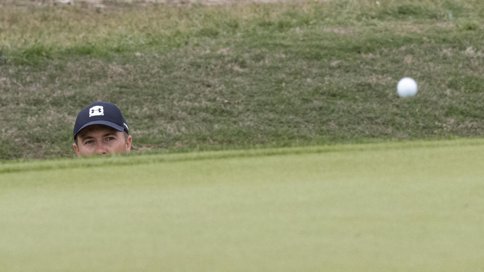 Jordan Spieth watches the ball after hitting from a bunker on the 12th hole during the final round of the Valero Texas Open golf tournament in San Antonio, Saturday, April 4, 2021. (AP Photo/Michael Thomas)