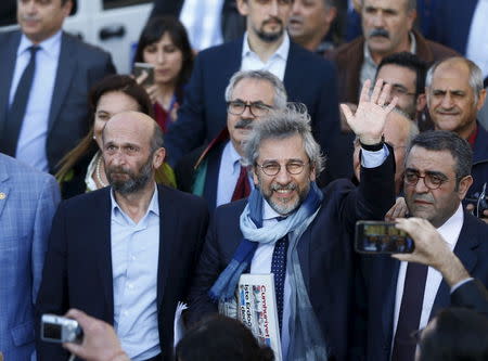 Can Dundar, editor-in-chief of Cumhuriyet, leaves at the Justice Palace after his trial in Istanbul, Turkey April 1, 2016. REUTERS/Osman Orsal