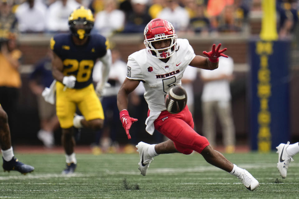 UNLV running back Vincent Davis Jr. (5) runs to recover a fumble against Michigan in the second half of an NCAA college football game in Ann Arbor, Mich., Saturday, Sept. 9, 2023. (AP Photo/Paul Sancya)