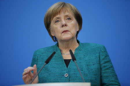 Christian Democratic Union (CDU) leader and German Chancellor Angela Merkel gives a statement together with Christian Social Union (CSU) leader Horst Seehofer and Social Democratic Party (SPD) leader Martin Schulz after coalition talks to form a new coalition government in Berlin, Germany, February 7, 2018. REUTERS/Axel Schmidt