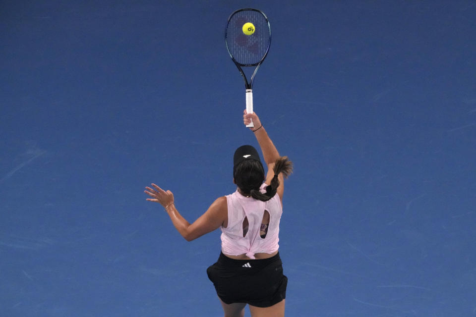 Jessica Pegula of the U.S. plays a shot back over her head to Victoria Azarenka of Belarus during their quarterfinal match at the Australian Open tennis championship in Melbourne, Australia, Tuesday, Jan. 24, 2023. (AP Photo/Dita Alangkara)