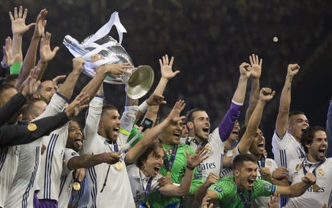 Sergio Ramos lifts the Champions League trophy as Real Madrid celebrate winning the UEFA Champions League Final between Juventus and Real Madrid at National Stadium of Wales on June 3, 2017 in Cardiff, Wales - Credit: Getty Images