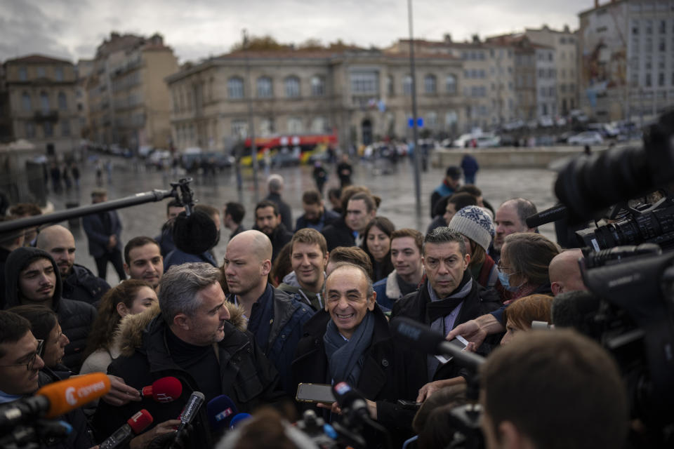 FILE - Far-right political talk-show star Eric Zemmour speaks to media outside of the Major Cathedral in Marseille, southern France, Nov. 27, 2021. A far-right former TV pundit with multiple hate-speech convictions is poised to officially enter the race for France's presidency, having already shaken it up with his anti-immigration, anti-Islam invective. (AP Photo/Daniel Cole, File)